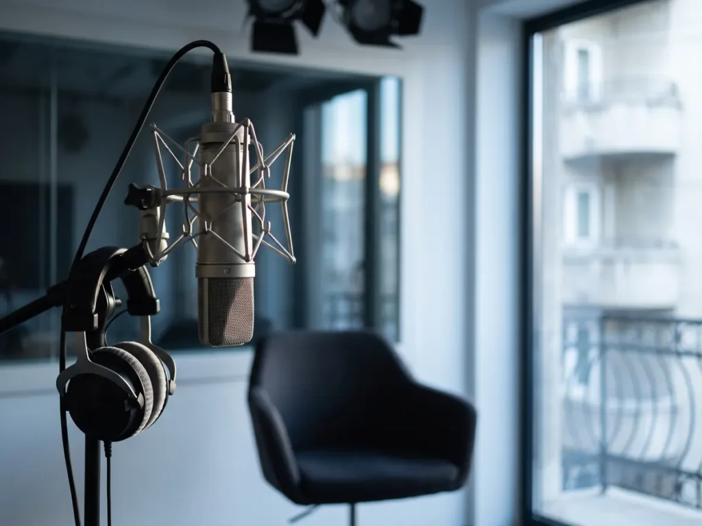 Microfon de studio pe brat articulat, in fata scaunului gol al invitatului dintr-un mic studio de televiziune